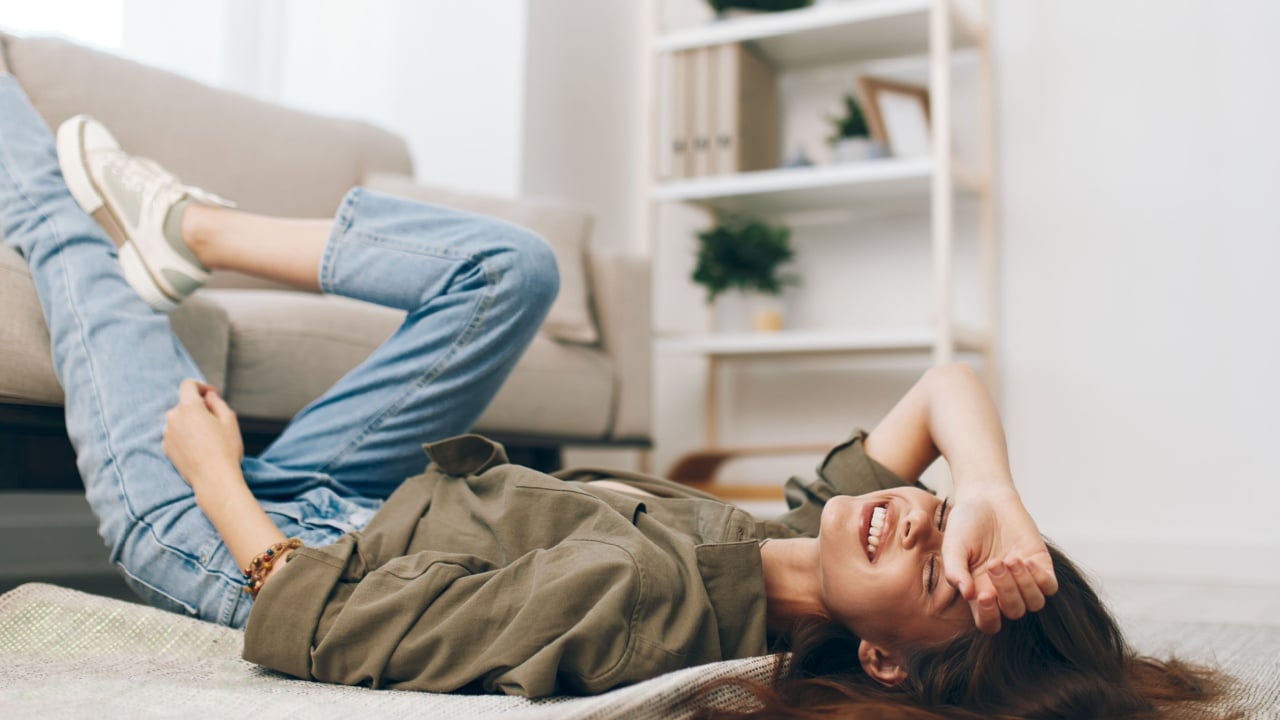 Cosy Living: Woman Relaxing on Modern Sofa in Peaceful Apartment