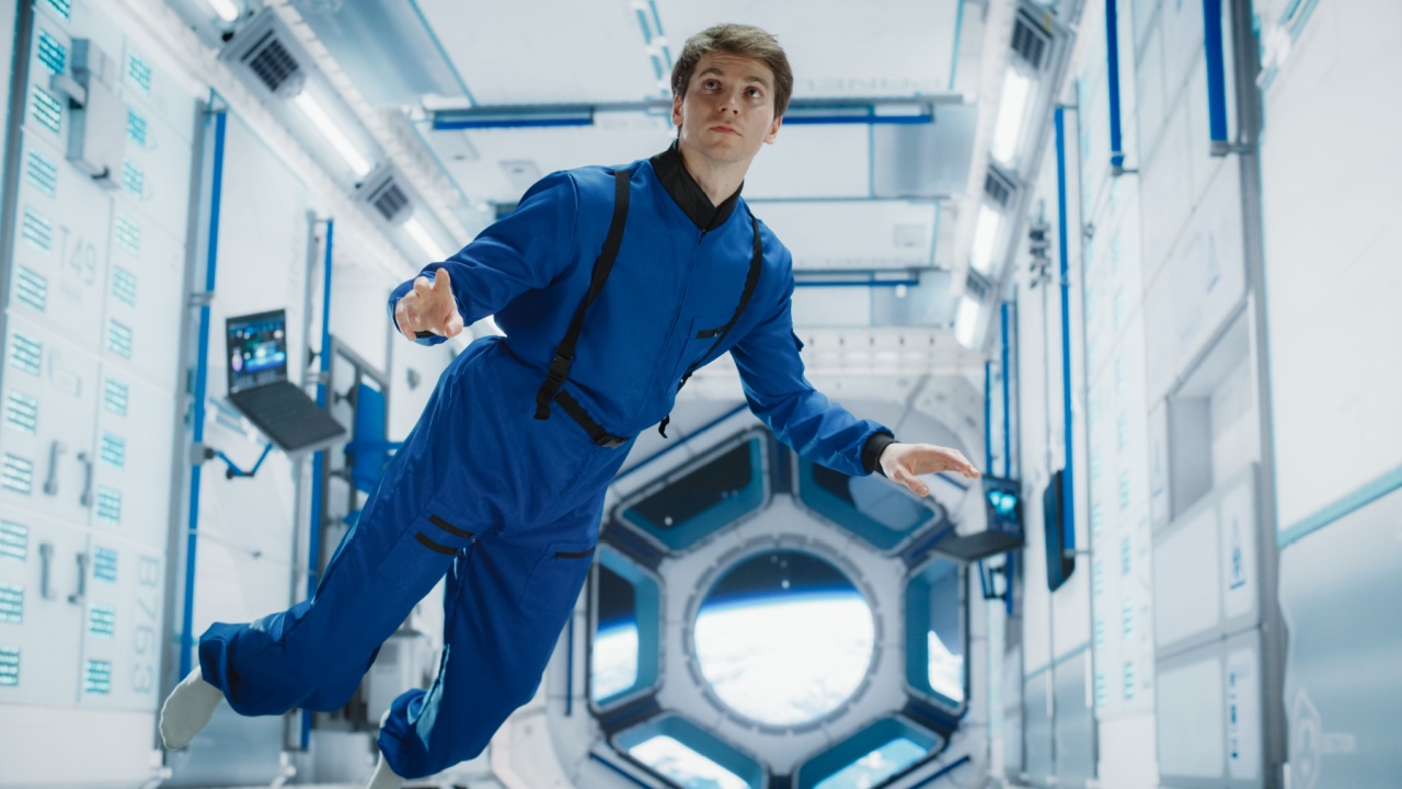 Male Astronaut in Blue Spacesuit Floating near Space Station, Performing Tasks. Human Achievement in Space Exploration. Cosmos Inspires Scientific Discovery and Technological Advancement