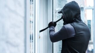 Man, criminal and crowbar for house crime, home invasion and breaking entering attempt with tool. Apartment, robbery and burglary or trespassing on property, security breach and owners safety risk