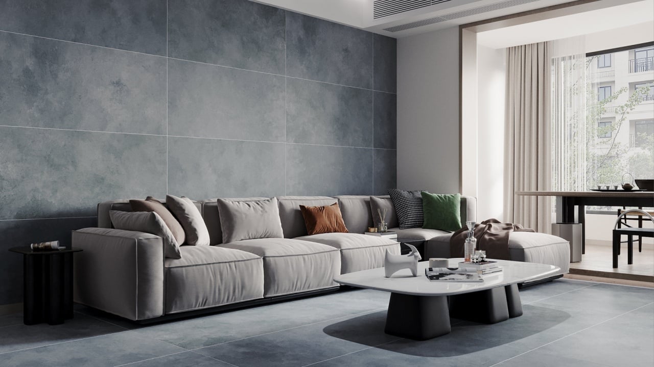 Elegant interior living area including a dark mat marble floor, a comfy grey sofa, a ceramic coffee table, and a window overlooking a garden.