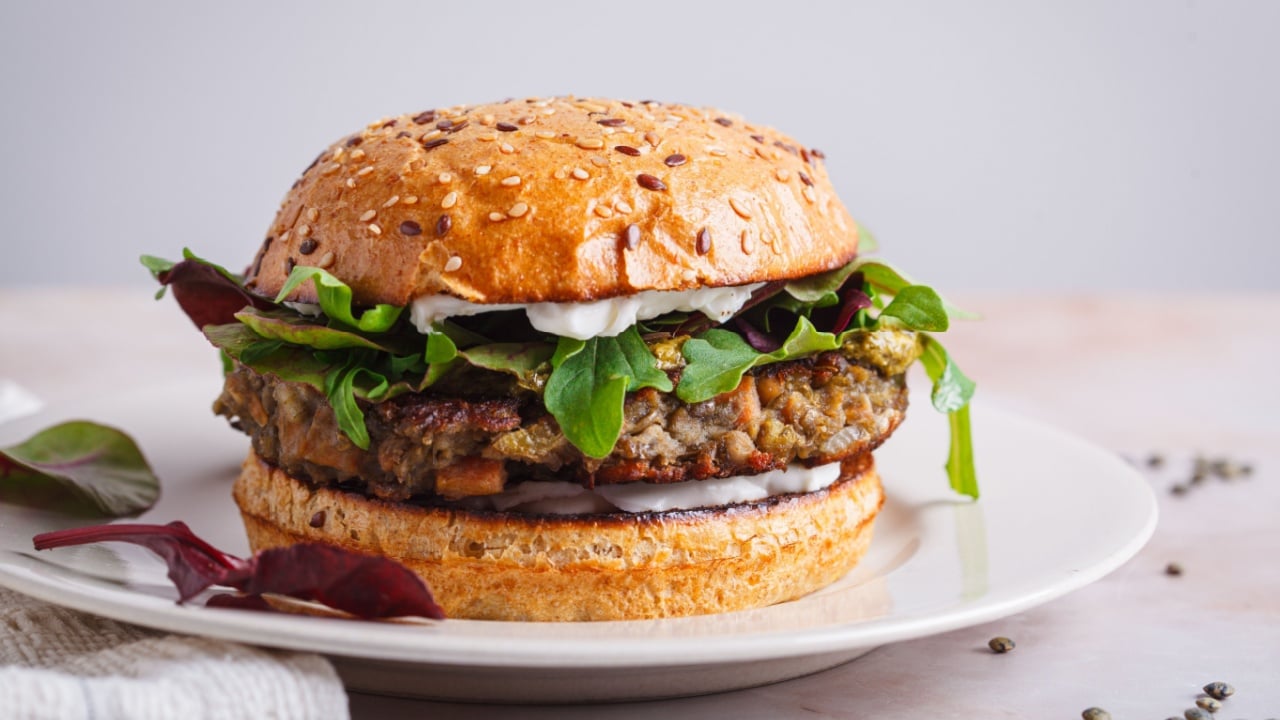 Vegan burger with lentil cutlet, pesto and vegan cream cheese.