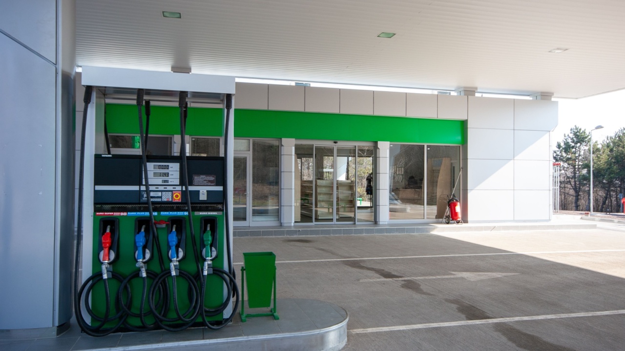 Modern, clean gas station with multiple fuel pumps and convenience store entrance, ideal for themes of travel, transportation, and energy infrastructure