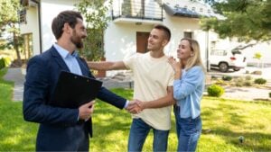 Real state agent talking to the clients after a successful deal