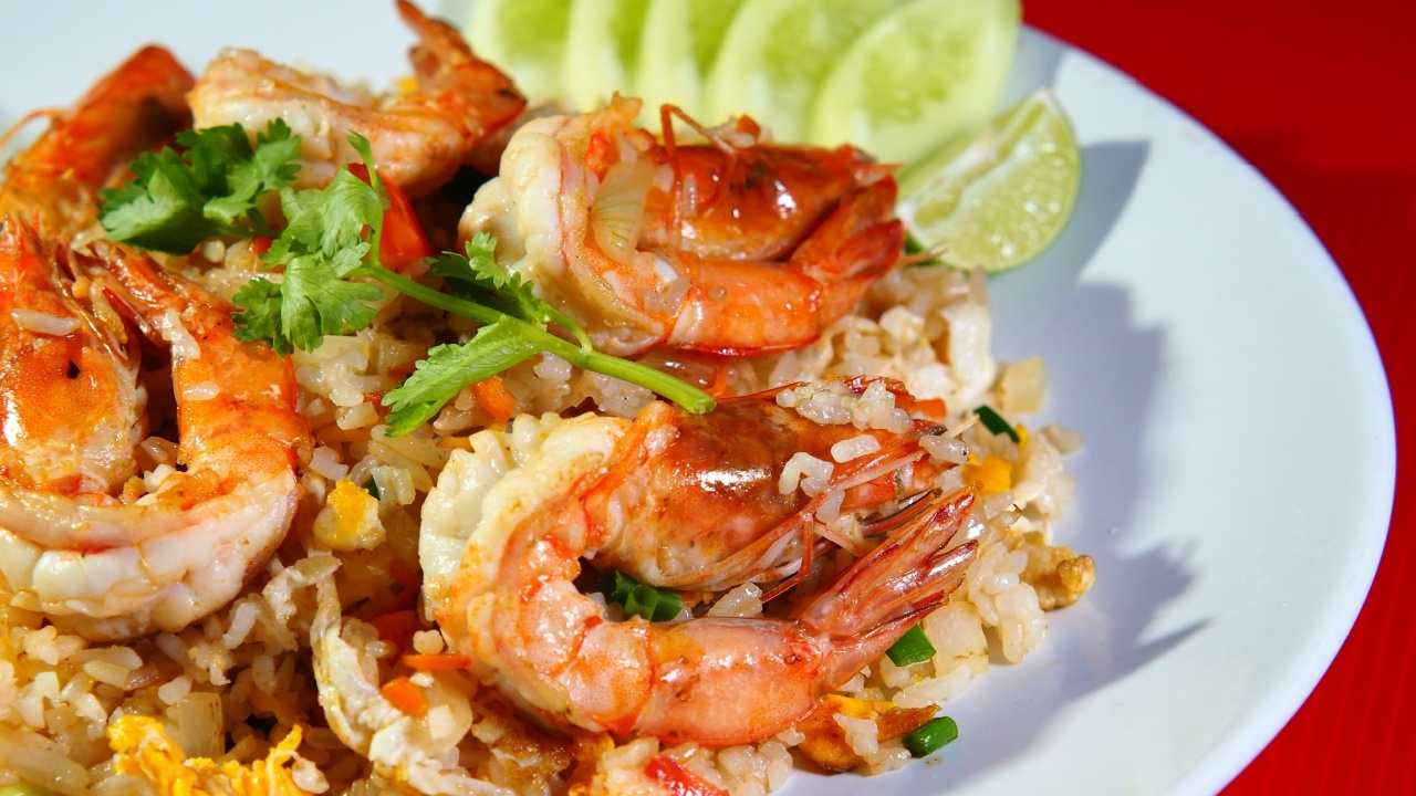 Close up of Egg Fried Rice with Shrimp on a White Plate over a White Background