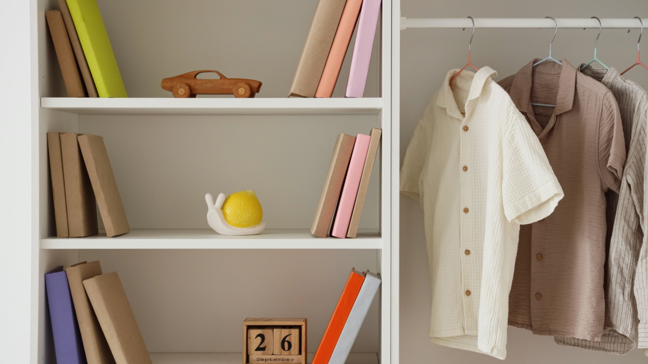 Closet with children's clothes, books and toys in room
