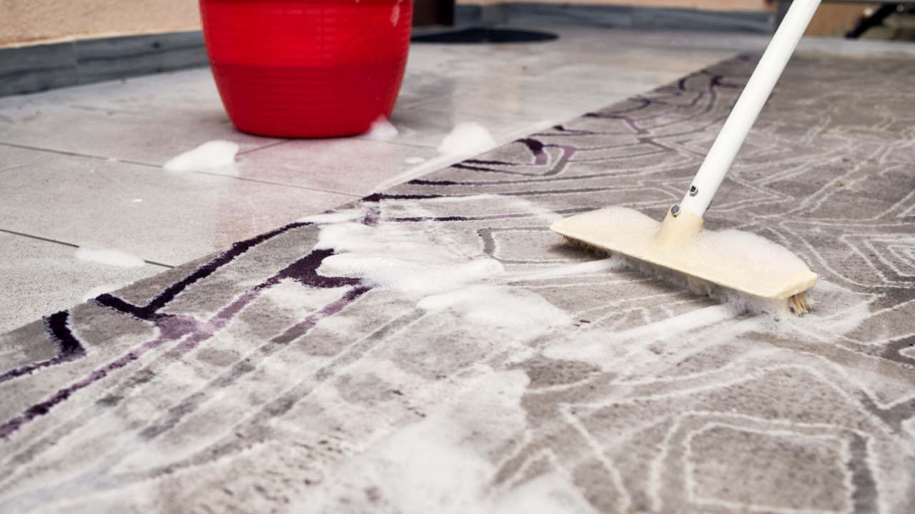 Rug cleaning with brush and soap foam close up