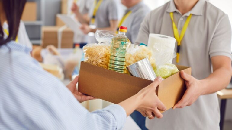 Food box giving to help, caring volunteer group working in charitable food foundation, make donation to needy, charity, separating donations stuff, food bank stocks, basic need provisions, free meal