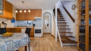 Alicante Spain 15 December 2025: Warm Torrevieja kitchen interior with dining table, wooden stairs, and homey atmosphere