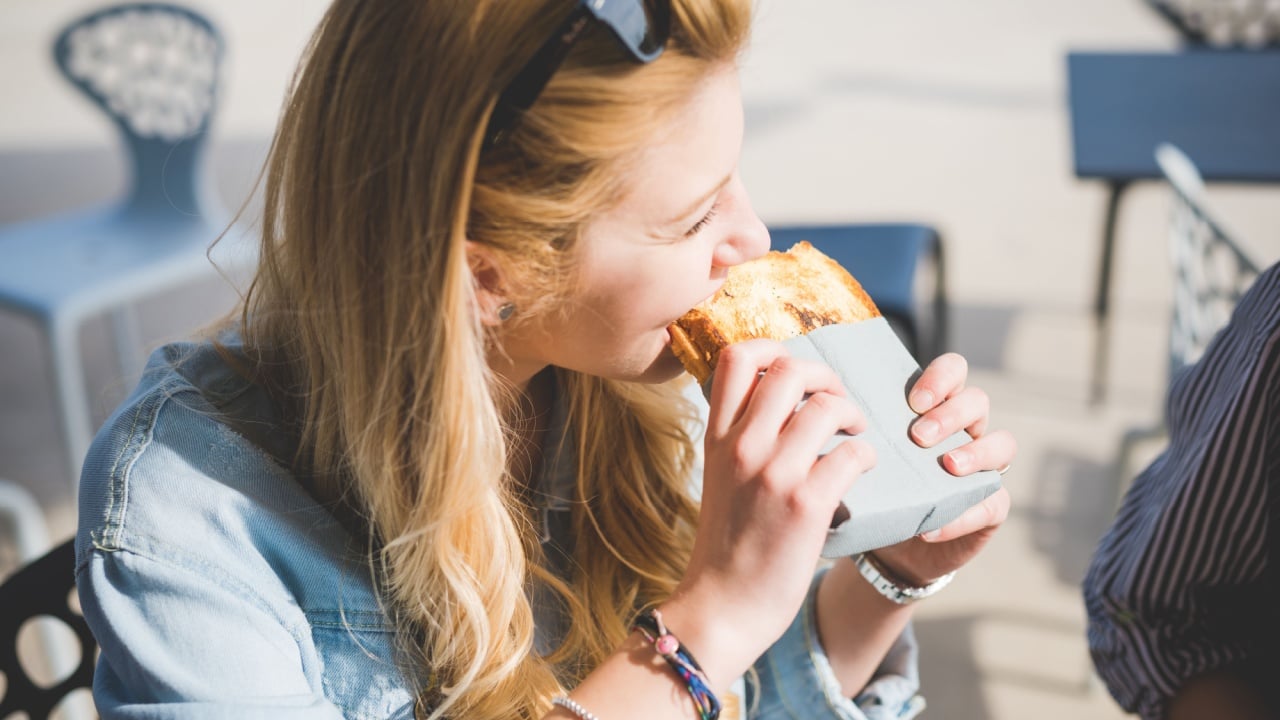 Two young handsome caucasian and eastern women having an happy hour in a bar - happy hour, relax, friendship concepts