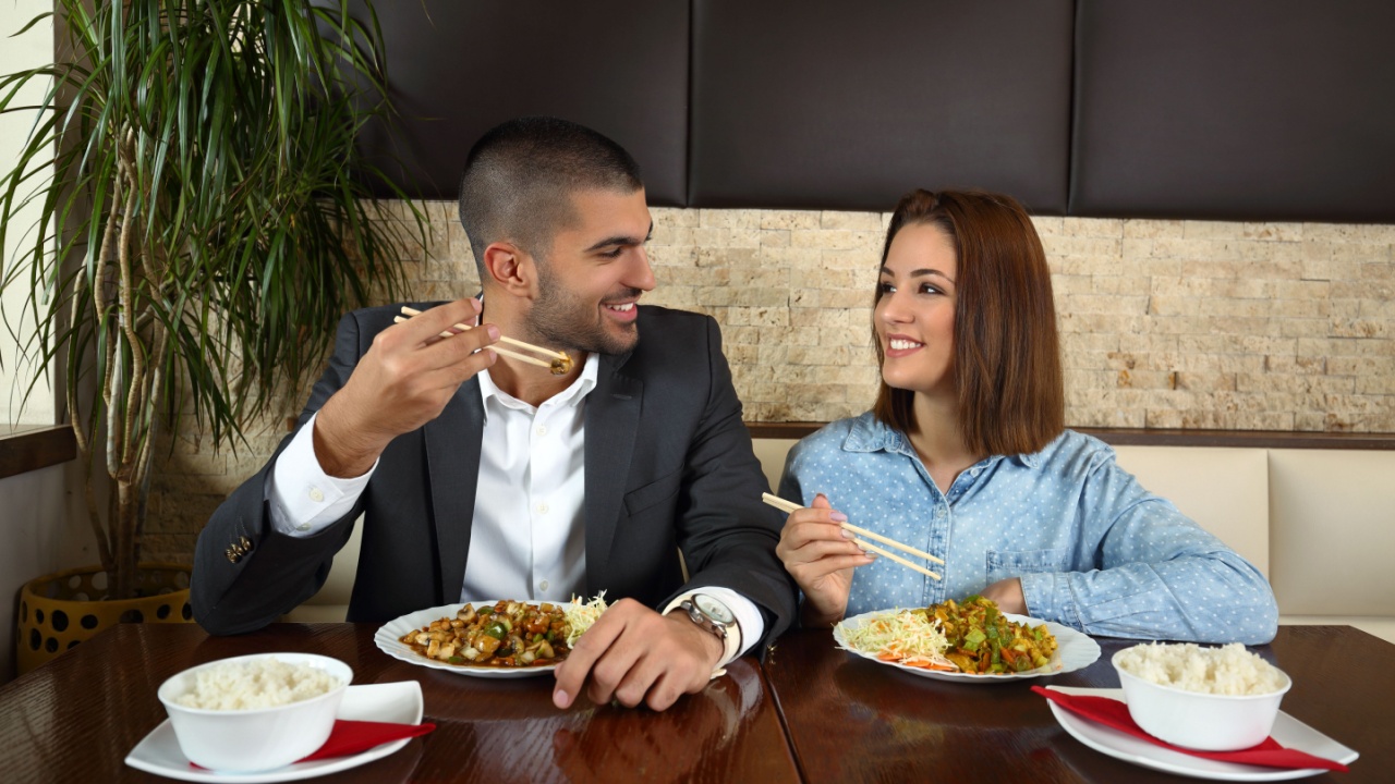 Young couple in love is enjoying a romantic lunch at the Chinese restaurant