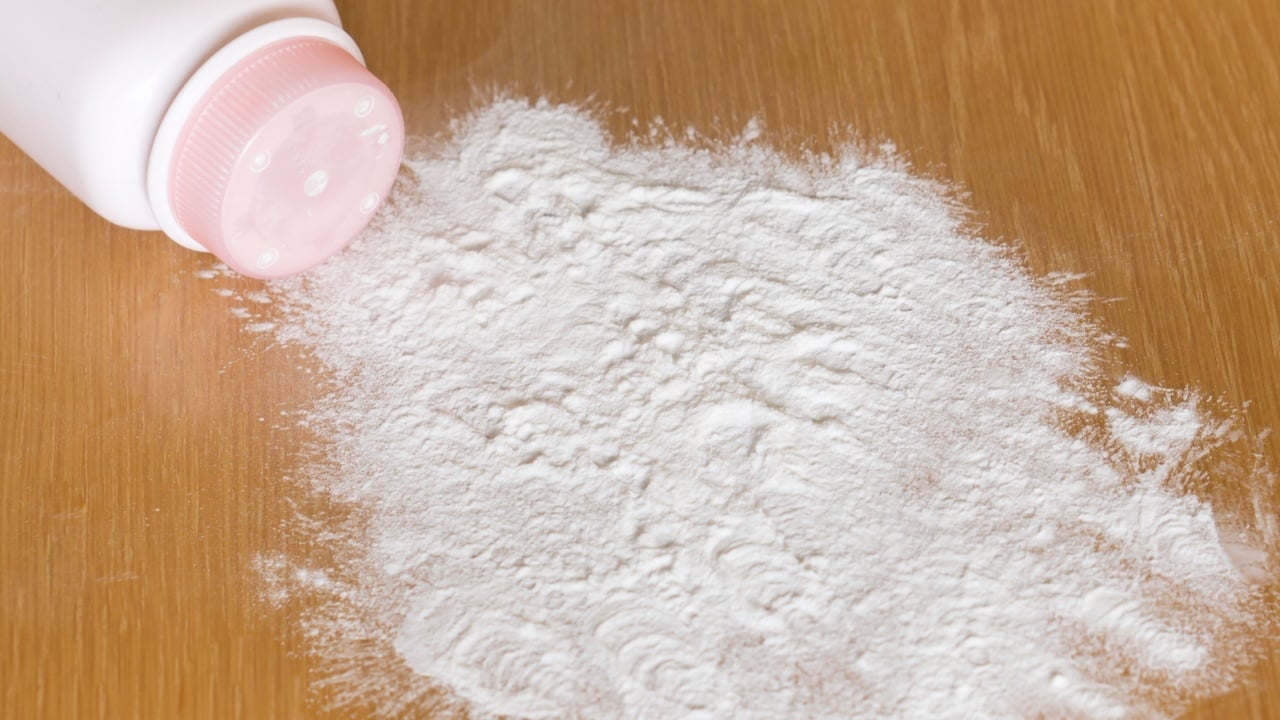 Baby talcum powder container on wooden background