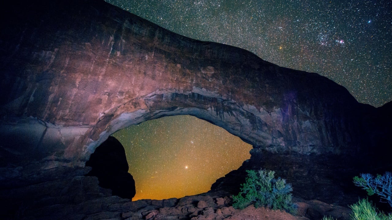 Arched rock formation and starry night sky, Arches National Park, Moab, Utah, USA