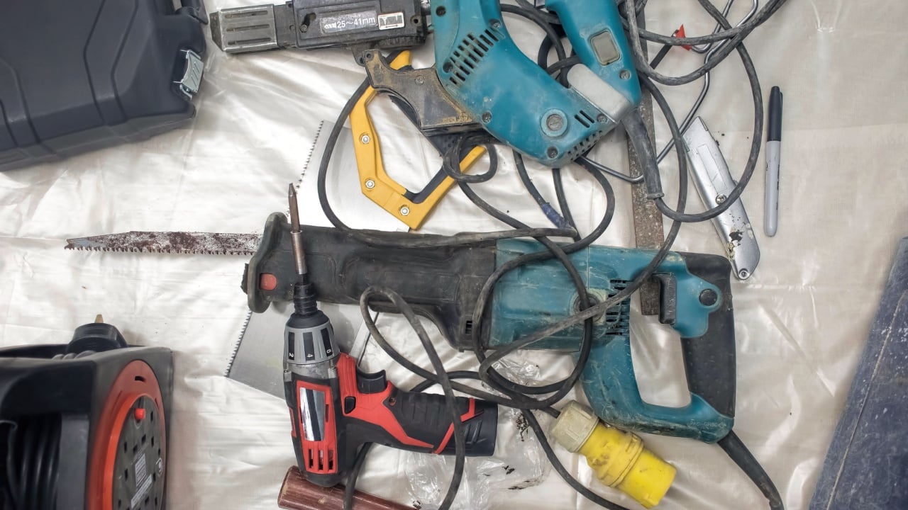 Collection of used power tools, DIY repair equipment.
