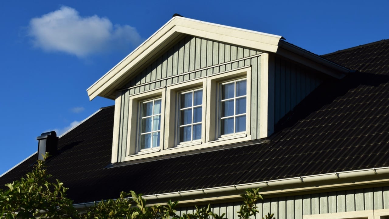 House with three top windows on the rooftop - Norway