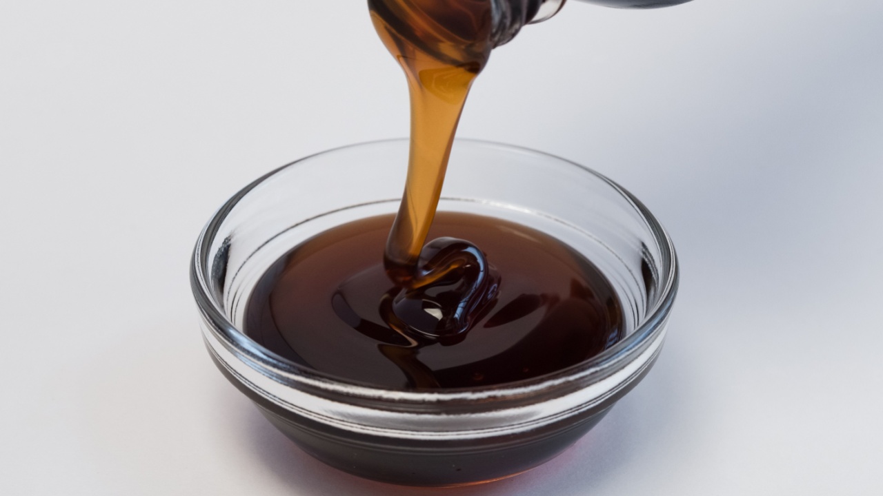 Pouring Dark Corn Syrup into an Ingredient Bowl