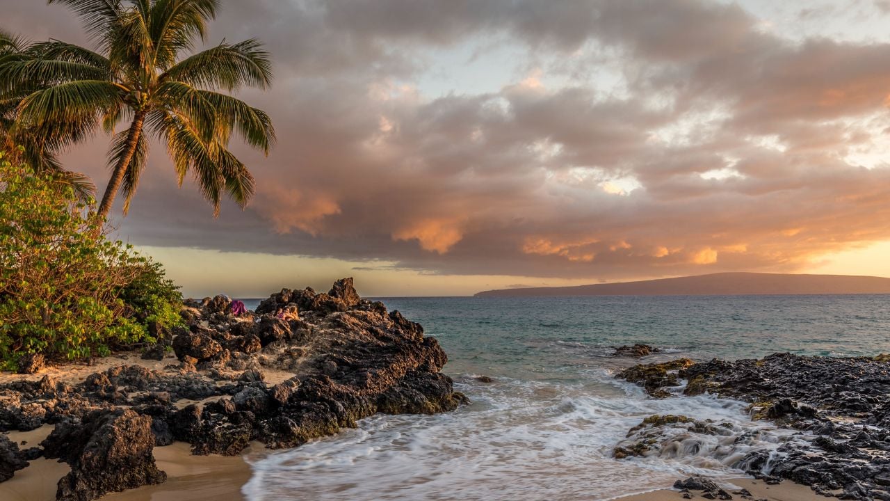 Sunset on Wedding Beach Hawaii pink clouds and ocean view palm trees and rocks