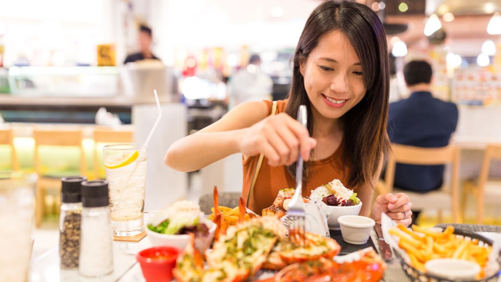 Woman enjoy her lobster in restaurant