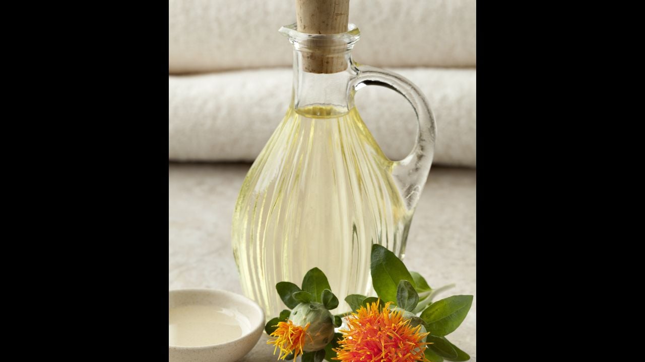 Bottle with cosmetic Safflower oil anf fresh orange flowers