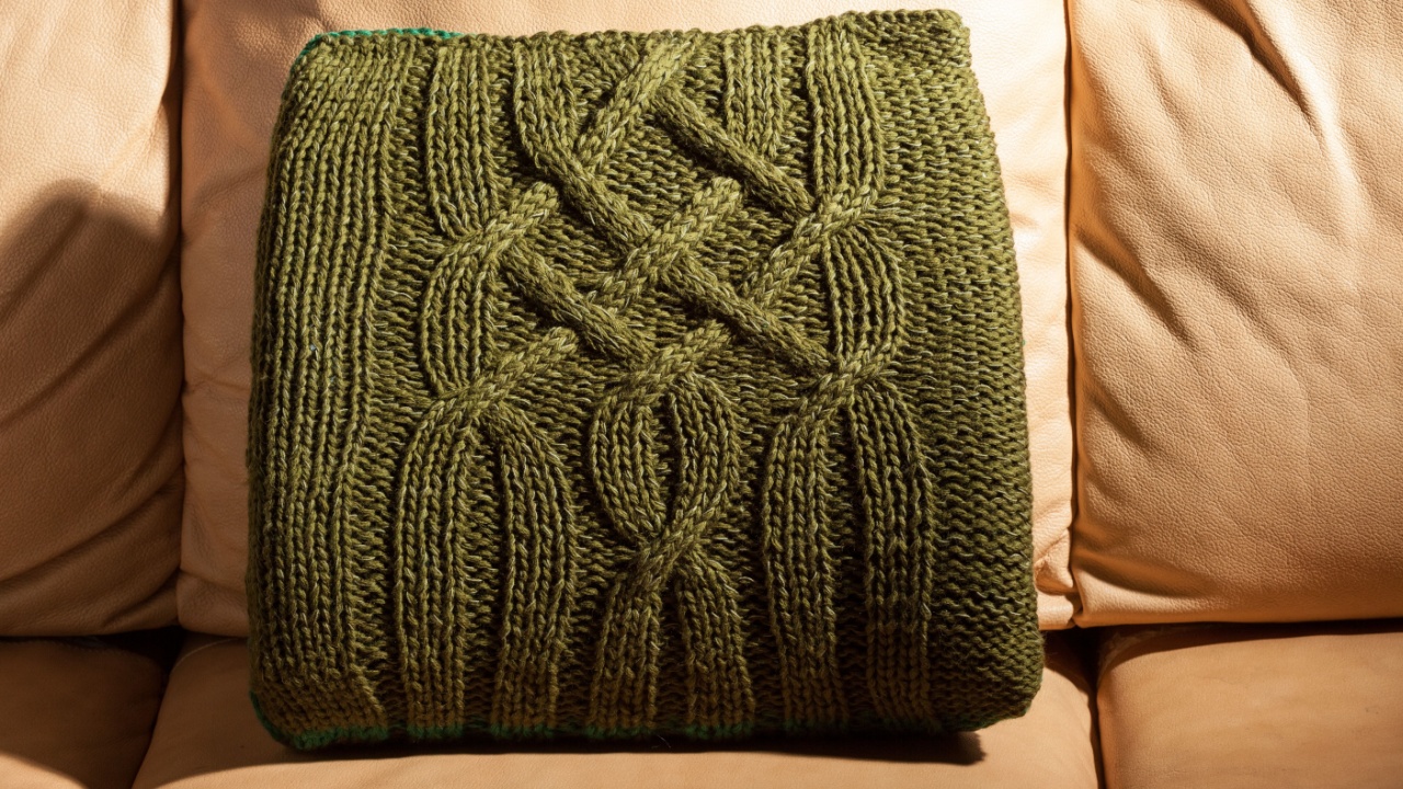 symbol of comfort pillow with knit pillow cover on the sofa. dim lights