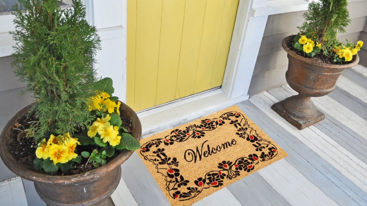 Beautiful welcome peach color coir doormat with flower border Placed outside door