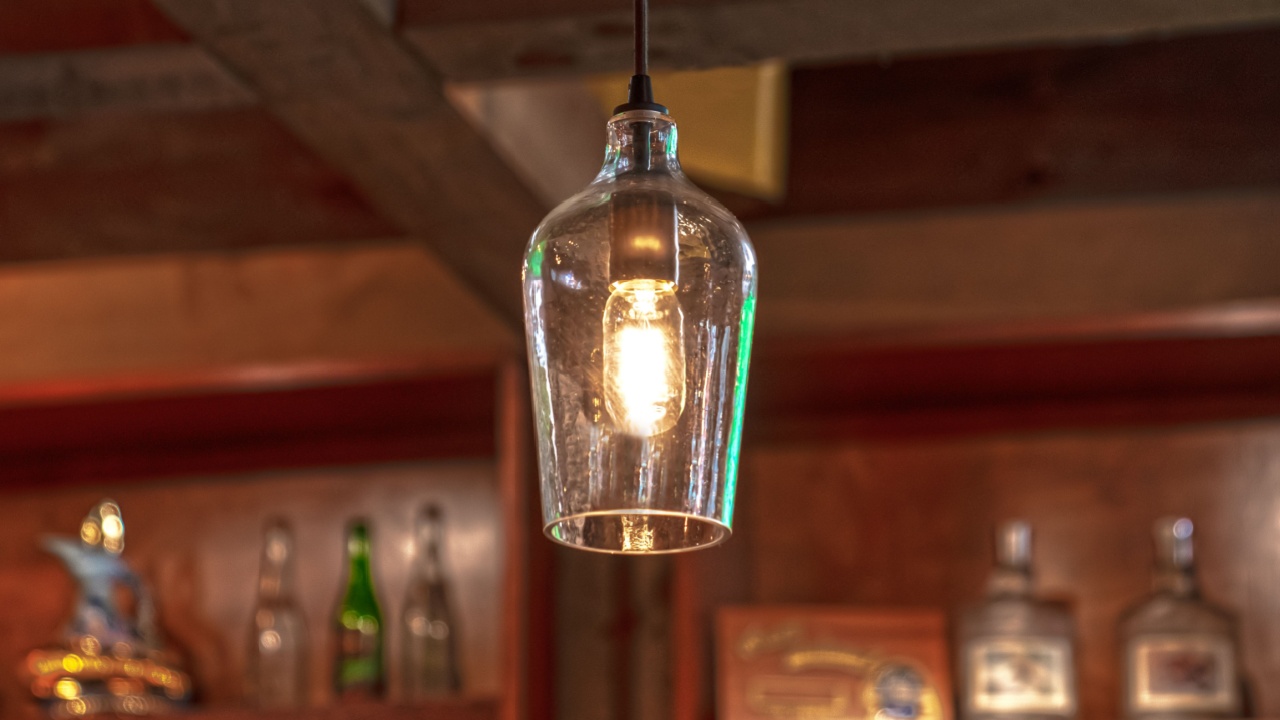 Ceiling pendant light with liquor bottles in background
