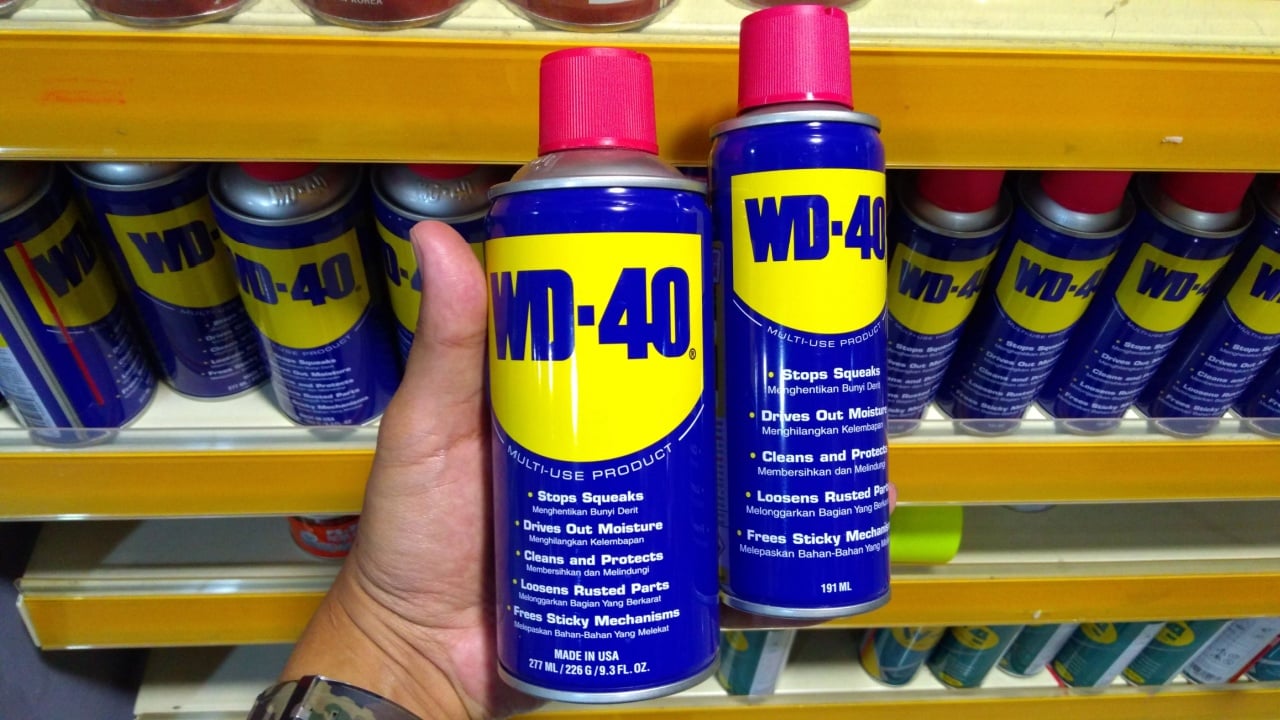 KUALA LUMPUR, MALAYSIA - MARCH 29, 2019: Hand hold WD-40. WD-40 is the trademark name of the penetrating oil and water-displacing spray is now available in Malaysia hardware stores.