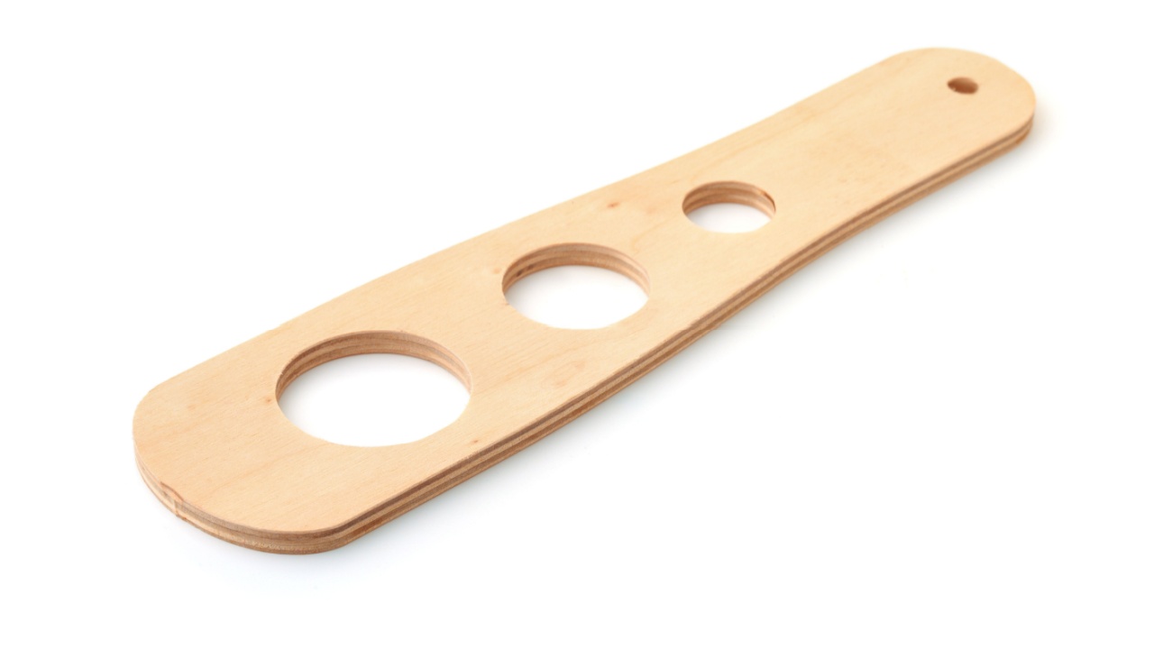 Wooden spaghetti pasta measuring tool isolated on white
