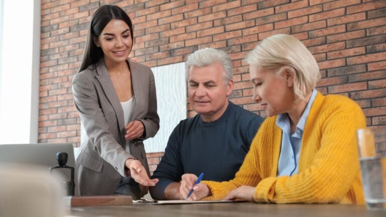 Female notary working with mature couple in office