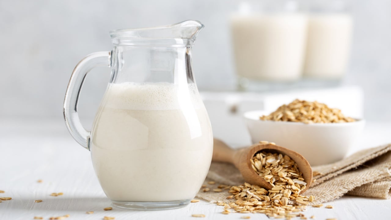 Oat milk. Healthy vegan non-dairy organic drink with flakes