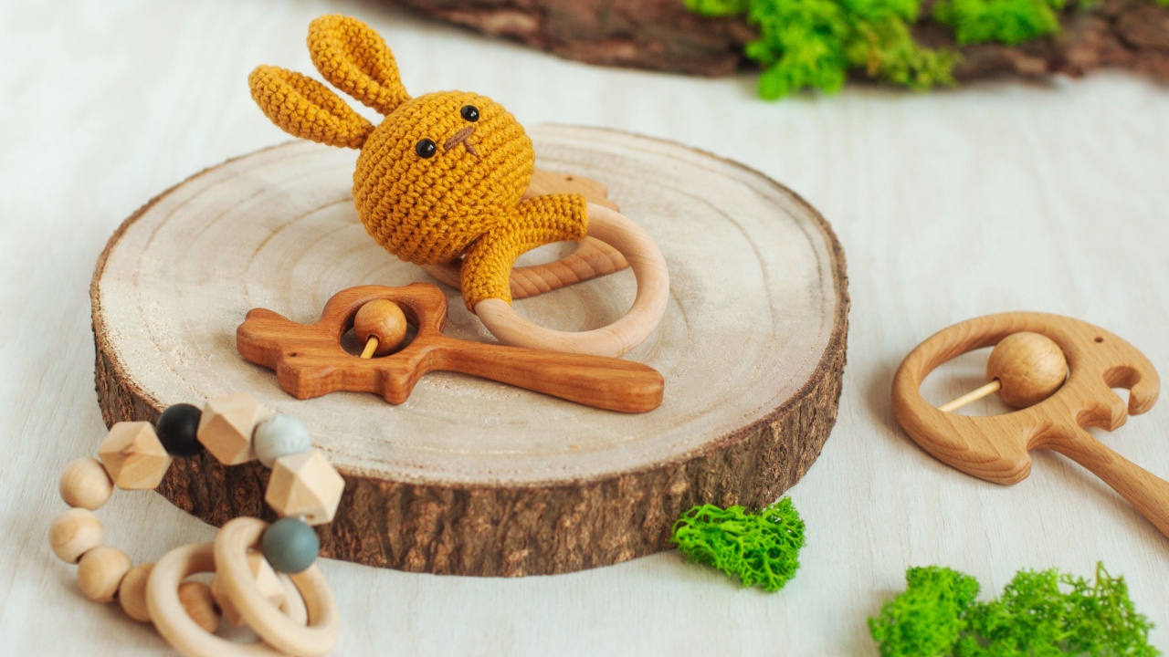 Wooden organic baby teether toys on light background with natural details