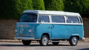 Turvey, Bedfordshire, UK - June 12th 2022. 1972 VOLKSWAGEN Camper Van driving through an English village