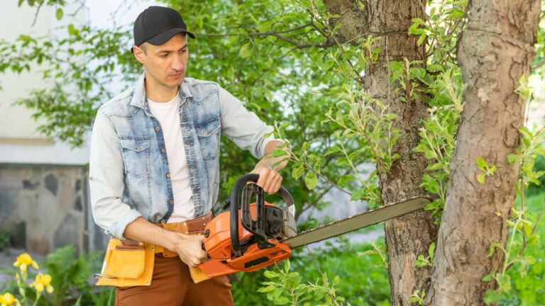 Man cutting a branch with chainsaw