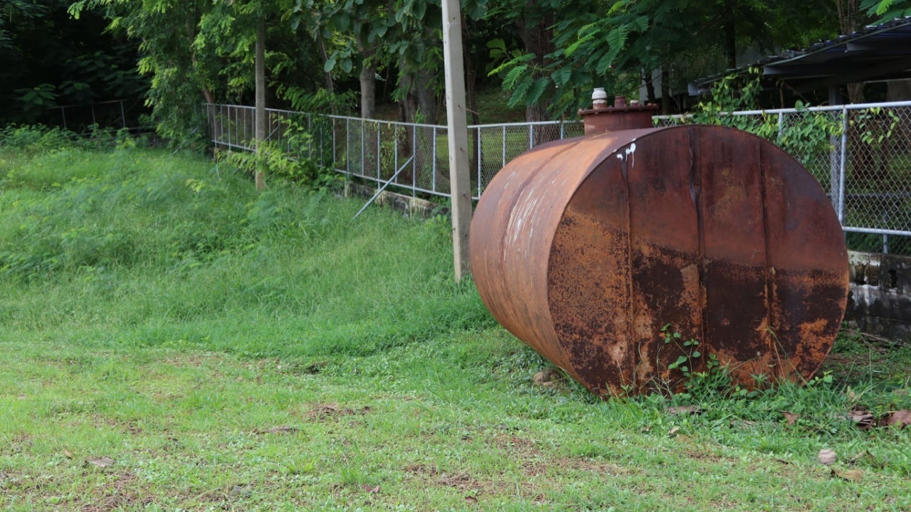 large oil storage tank Old and rusted, set up outdoor