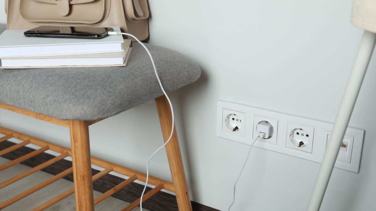Electric power outlet sockets with charger on white wall