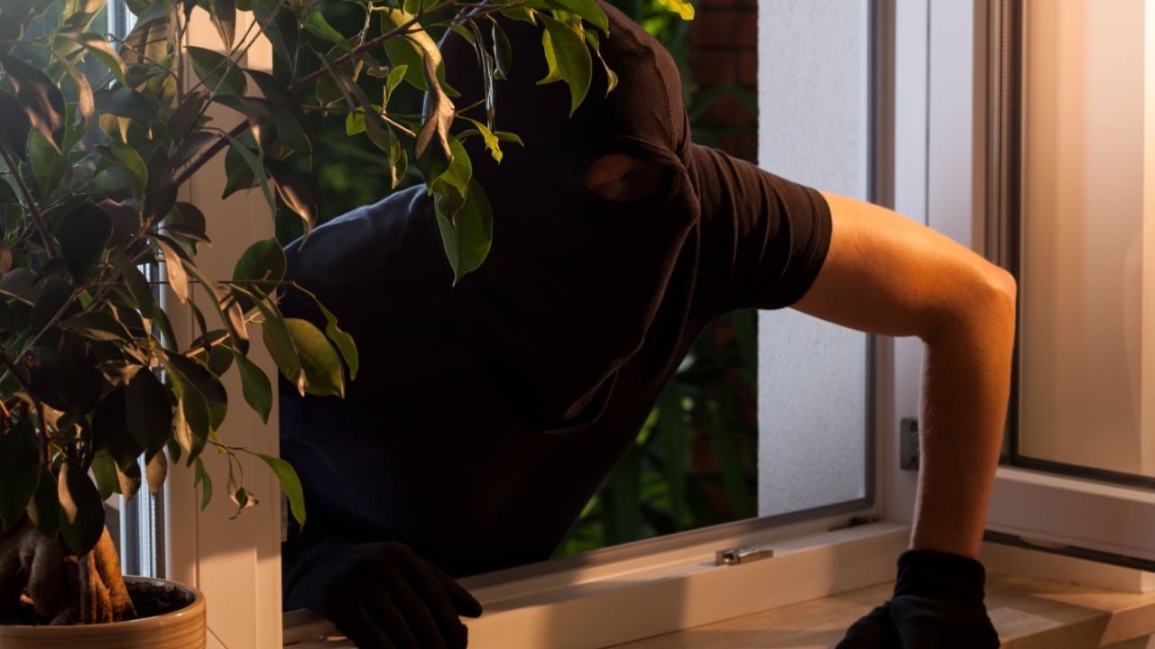 Masked robber enters the house at night