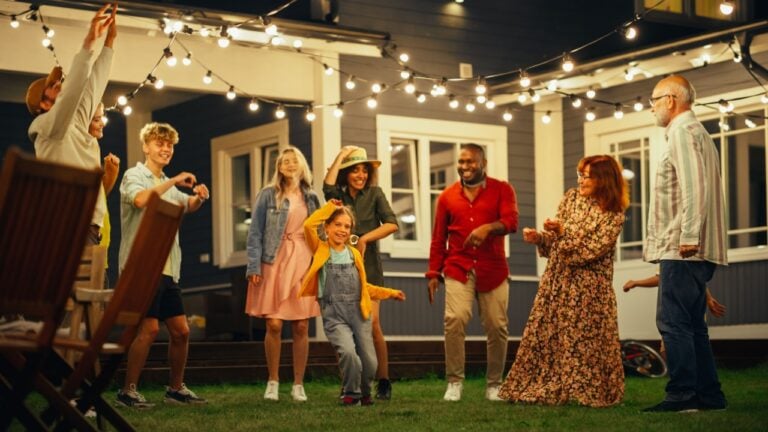 Group of Multicultural Diverse Friends and Relatives Having Fun and Dancing Together at an Evening Garden Party. Beautiful and Handsome Young and Old People Having Fun.