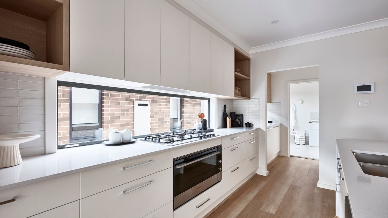 Interior photography of a white kitchen, butler's pantry and laundry in a modern family home.