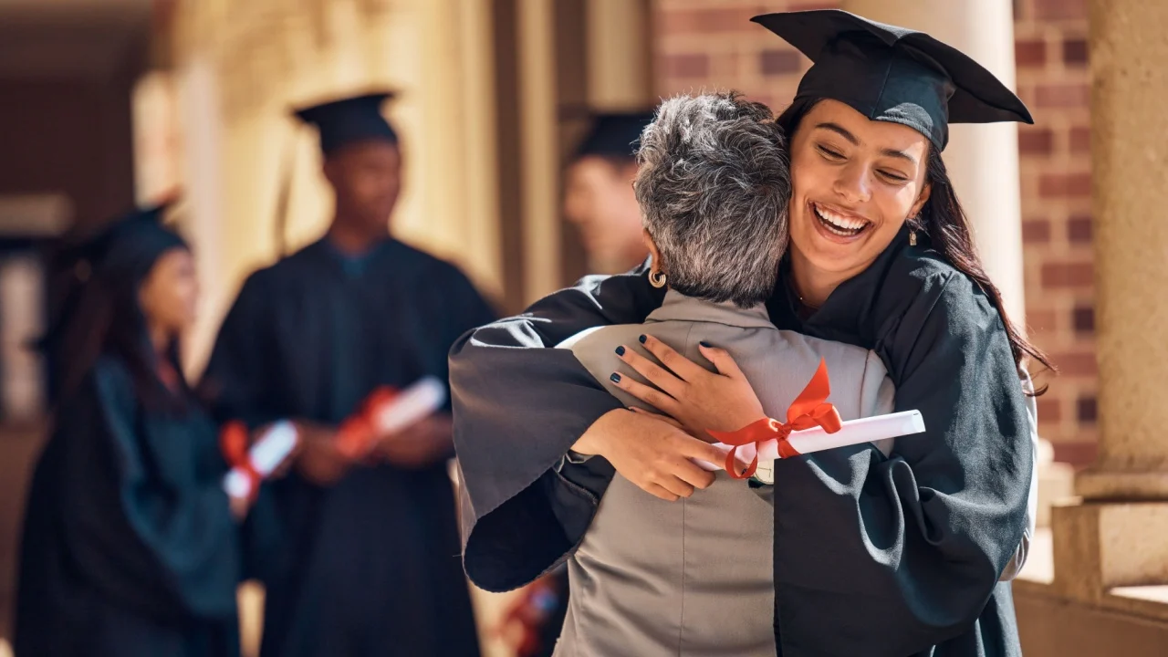 Hug, graduation and graduate, women and education achievement, success on university campus and certificate with academic goals reached. College, student and graduating ceremony, event and degree.