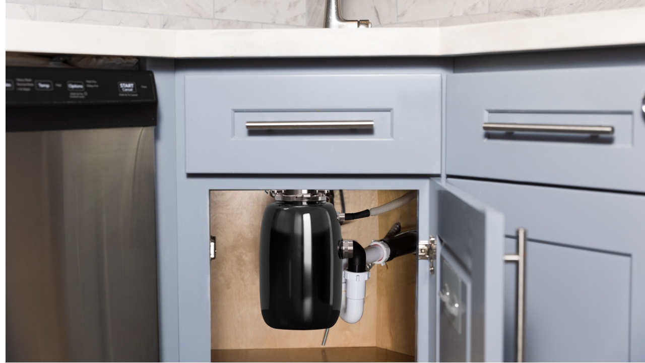 Garbage disposer installed under the sink in the kitchen