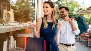 Portrait of a couple with shopping bags in the city. People sale love and happiness concept.