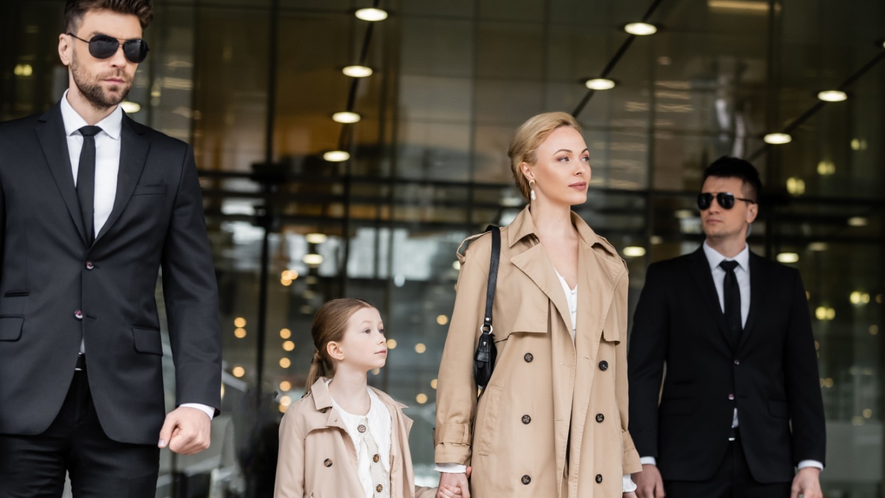 bodyguards walking next to blonde successful woman and preteen kid, entering hotel, private security, mother and daughter in trench coats, safety and protection, family travel, rich life