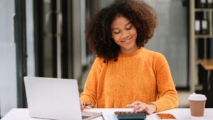 Hand women doing finances and calculate on desk about cost at home office.