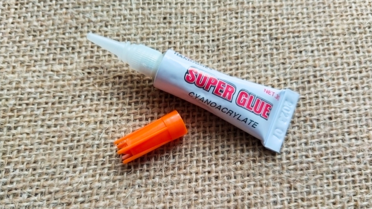 21 February 2024, Indonesia - close up instant adhesive glue with super sticky power against brown background