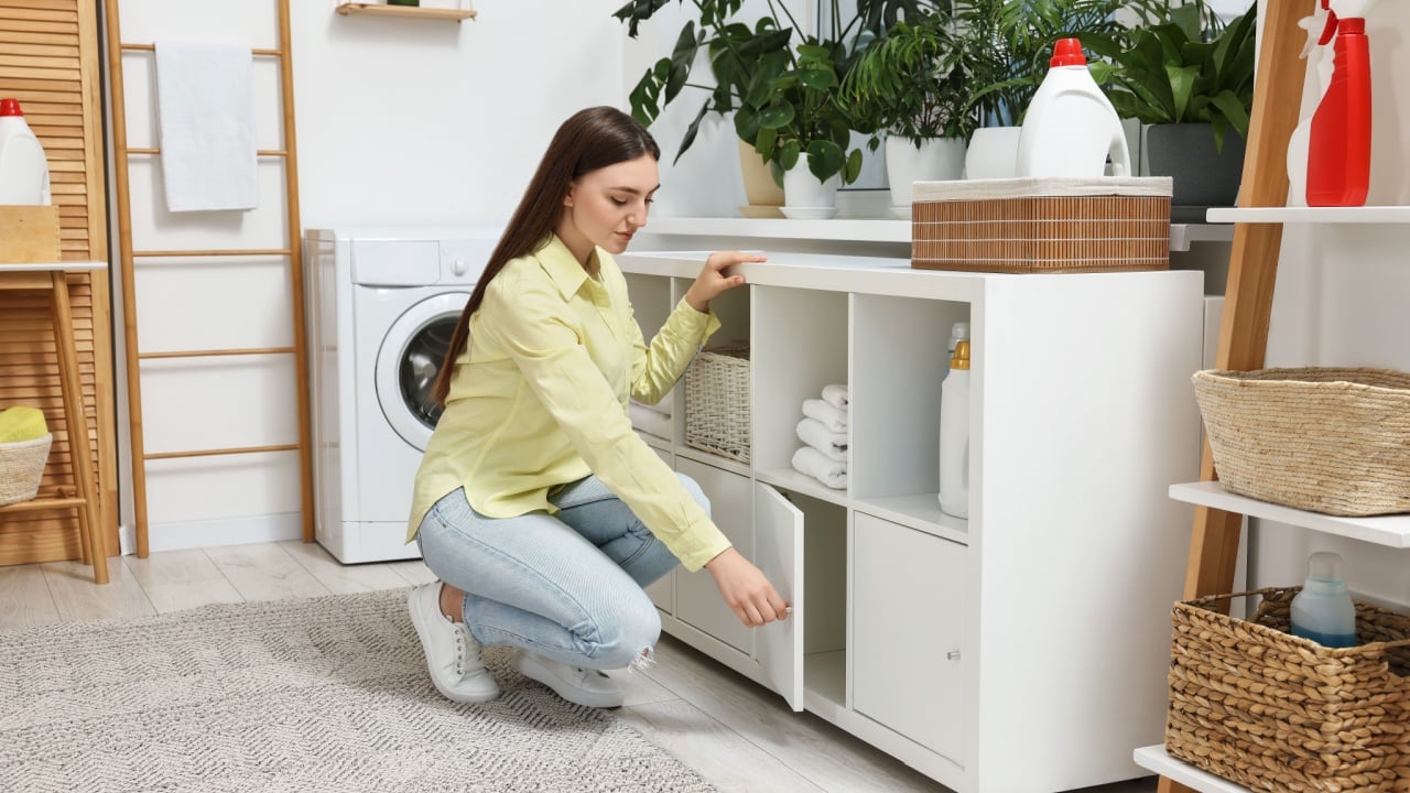Beautiful young woman in modern laundry room