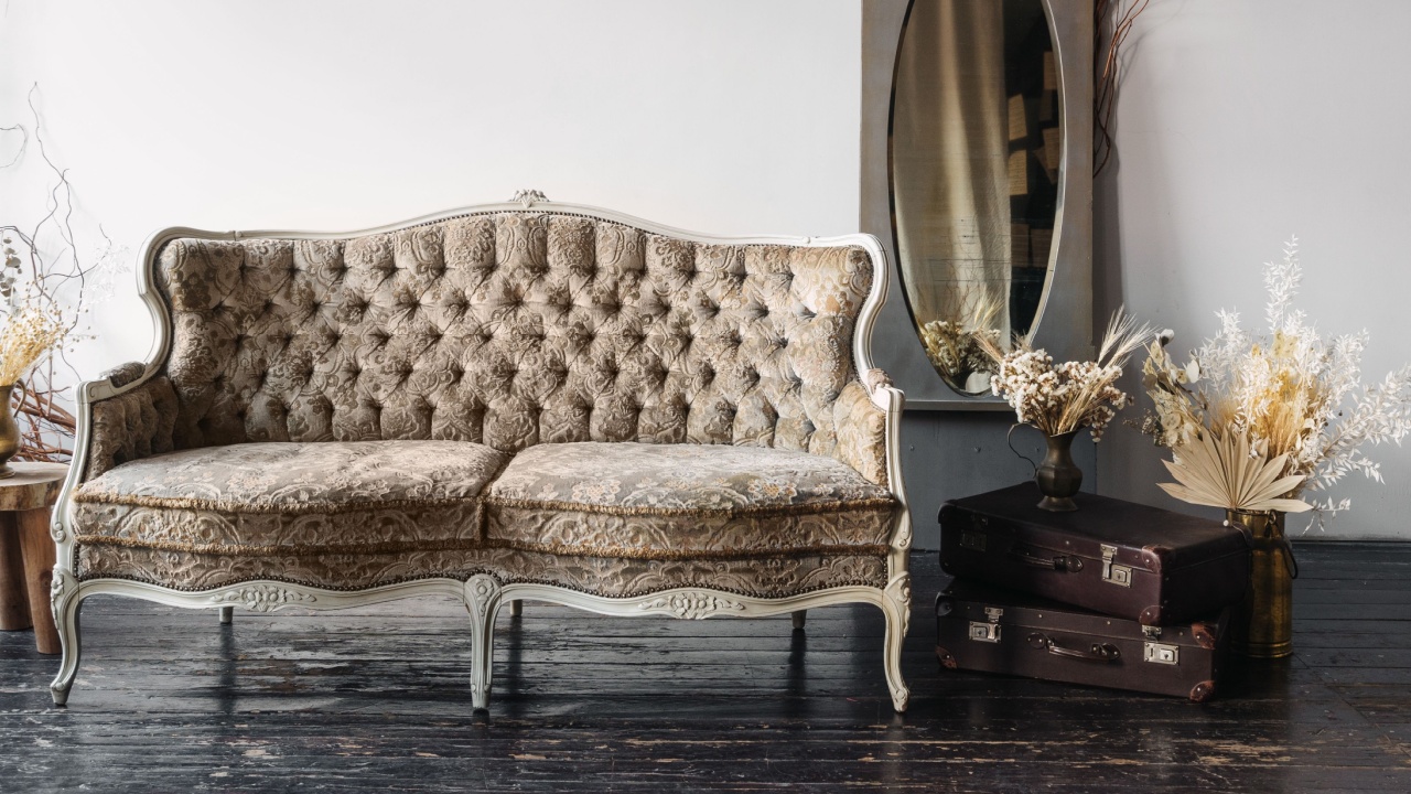 A vintage-style couch sits in a classic living room adorned with green sofa and natural elements. Elegant flowers and decorative items complement the serene atmosphere, creating a calming setting.