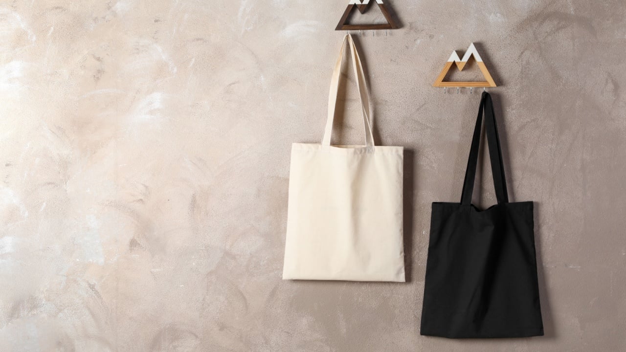 Eco bags hanging on grey wall,. Mockup for design