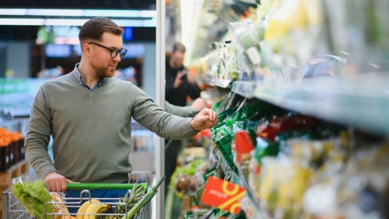 Man buying vegetables and fruit in grocery store