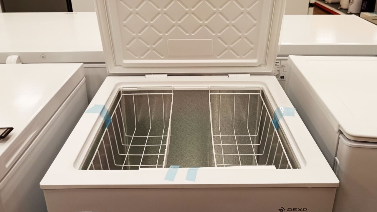 Aktau, Kazakhstan - February 20, 2025: White chest freezer with open lid in appliance store display.
