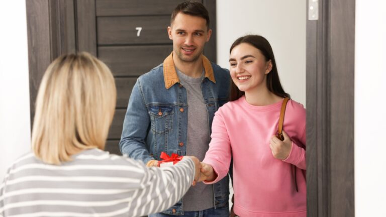 Woman welcoming new neighbors to her apartment