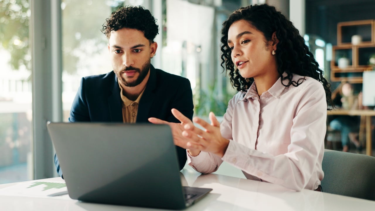 People, talk and meeting with laptop in office for finance report, ideas and investment pitch. Staff, explain and document with team for profit growth, revenue and chart results of financial proposal